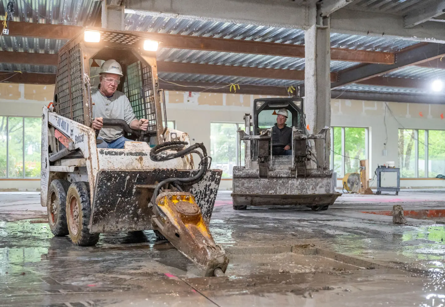 Person on machine destroying concrete floor