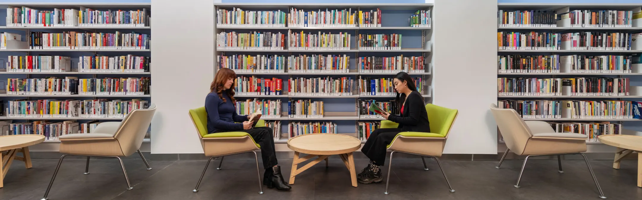 Women sitting and reading at library