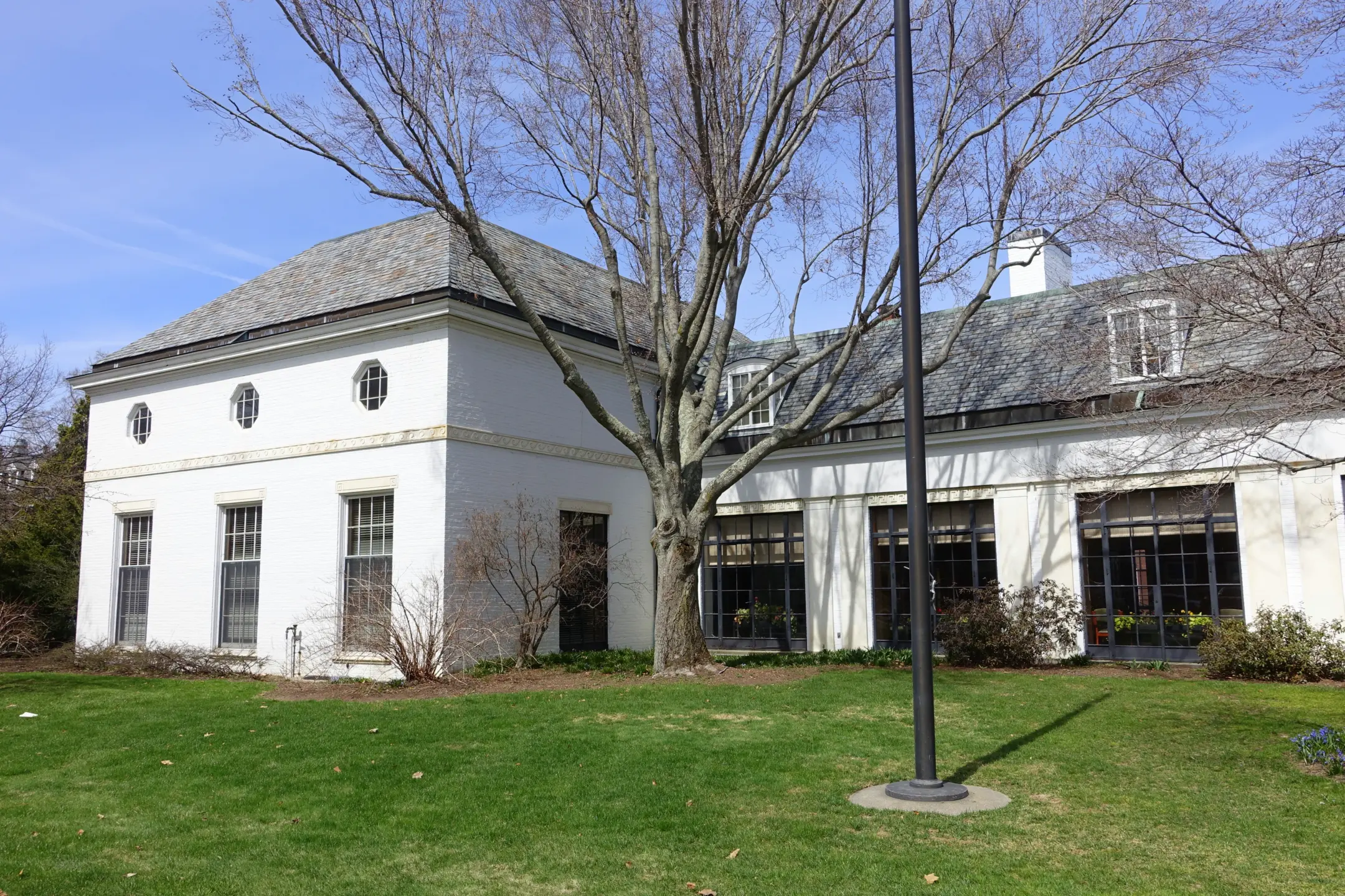 Exterior of white brick one story building