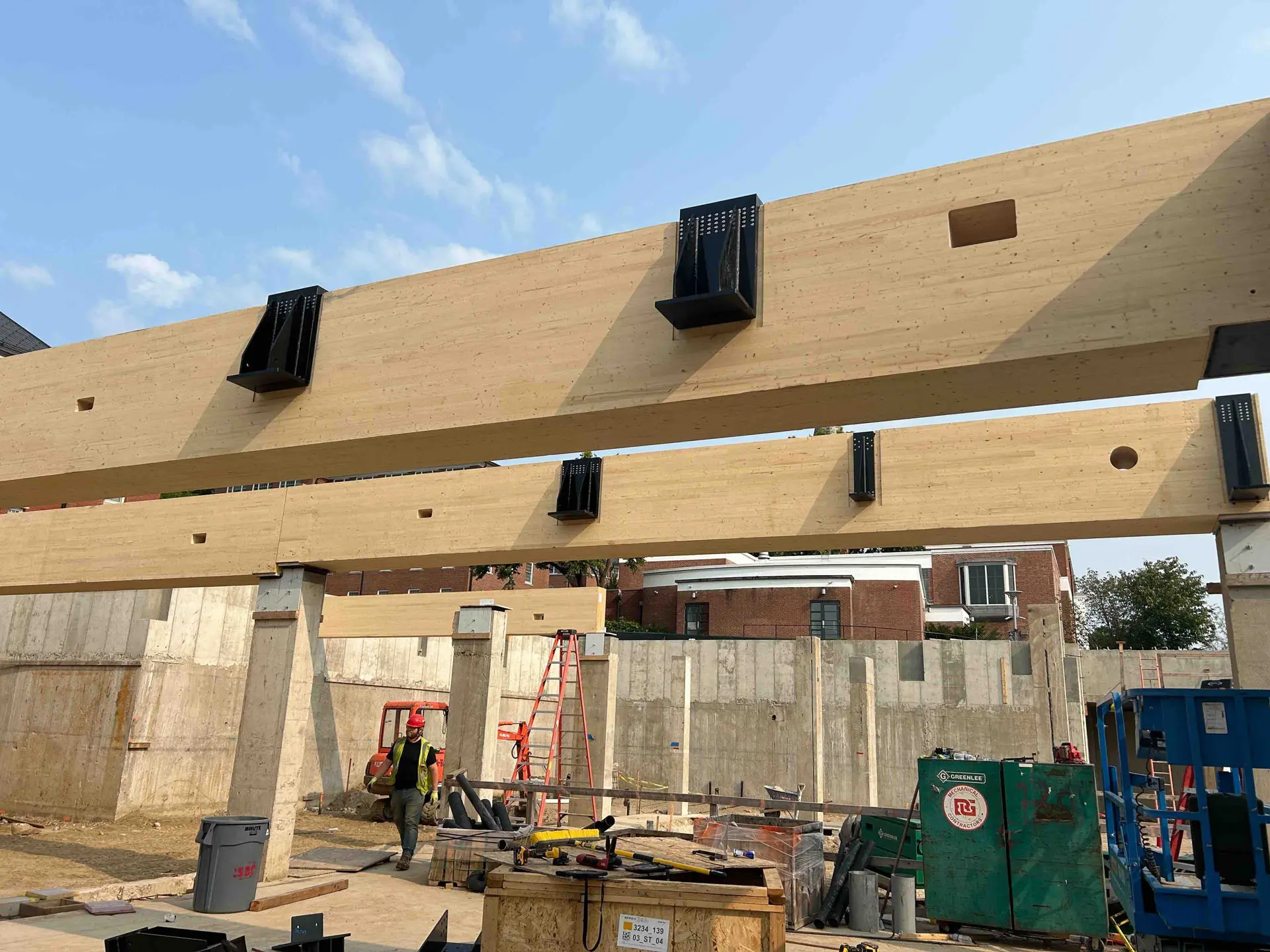 Upclose of cross timber beams with concrete foundation at Amherst College