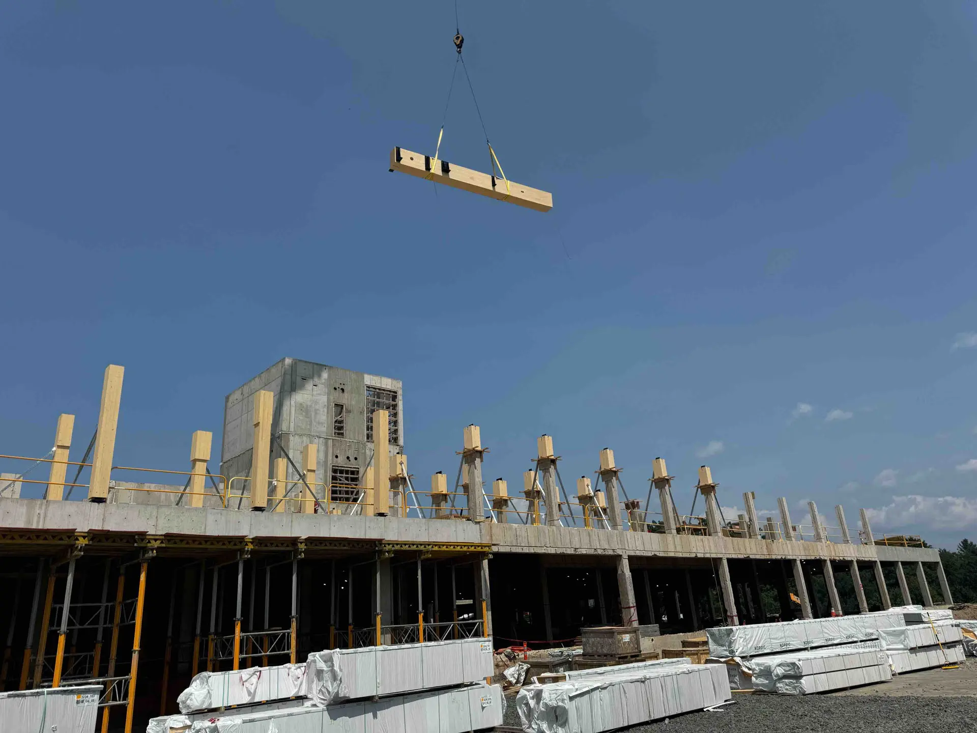 Crane placing cross timber beam at Amherst College