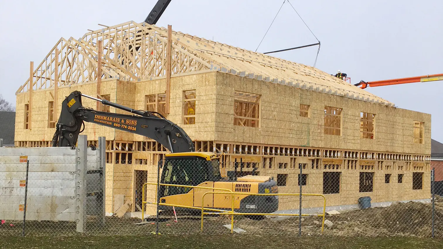 Wooden framing and a backhoe of the Pomfret Academy
