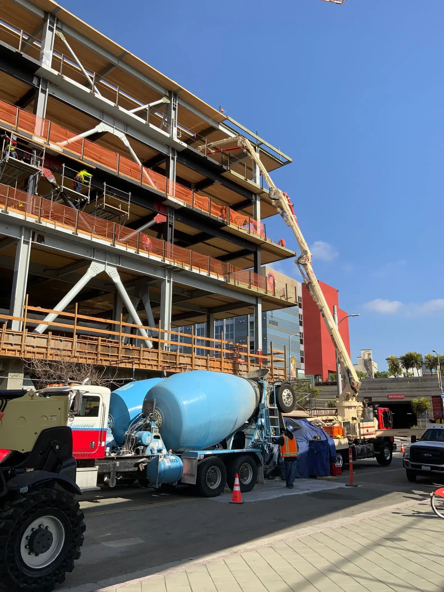 Concrete pour truck pumping concrete into the fifth floor of the 843 North Spring Street building