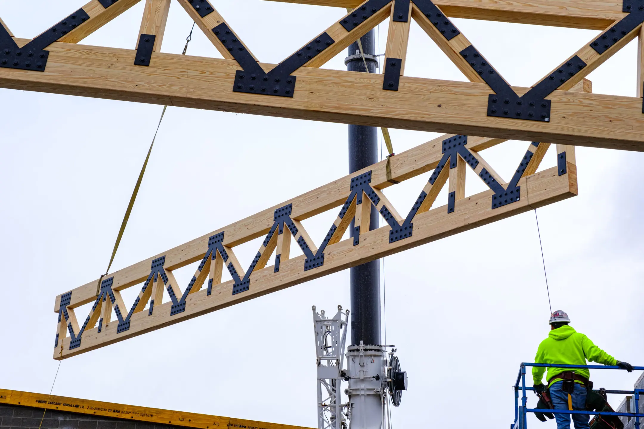 Wooden beams being lifted by crane