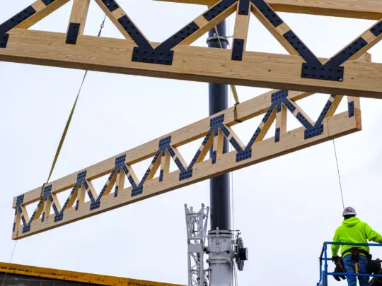 Wooden beams being lifted by crane