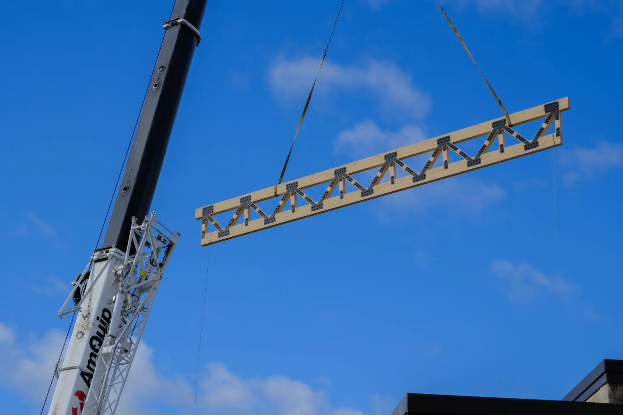 Timber truss being placed by crane at Eden Park Elementary School