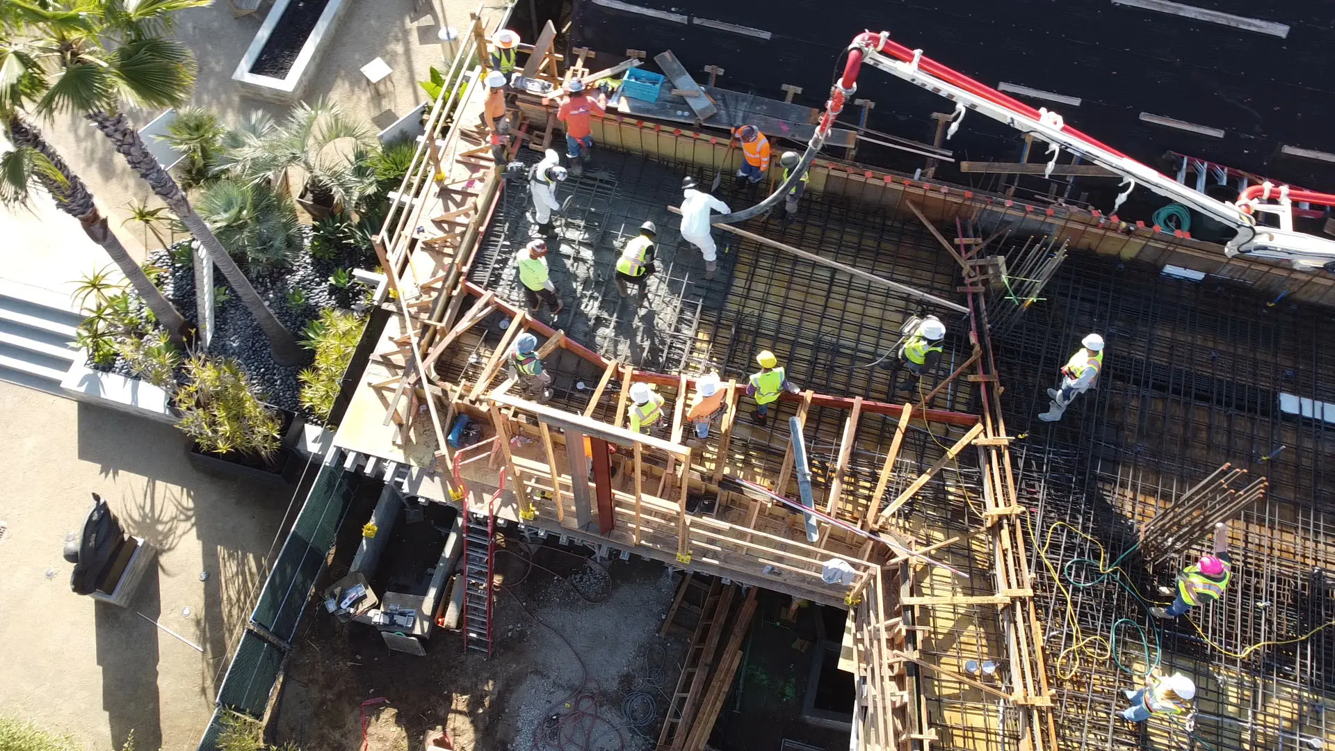 Overhead view of workers on rebar pouring concrete