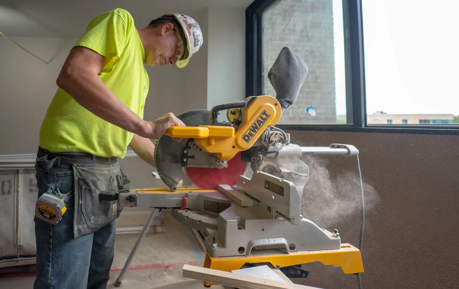Man using miter saw in apartment