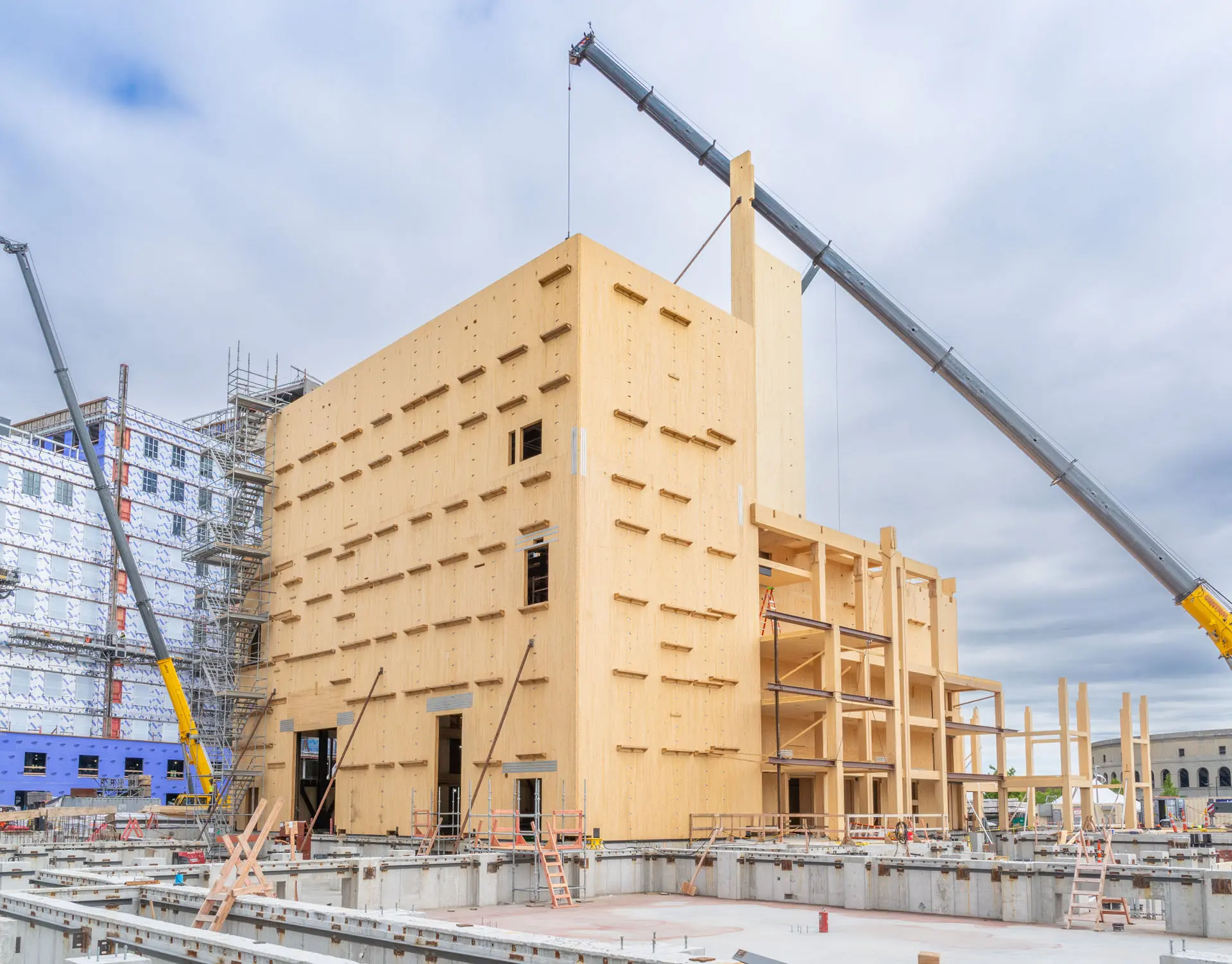 Exterior image of Harvard University American Repertory Theatre with crane placing beams
