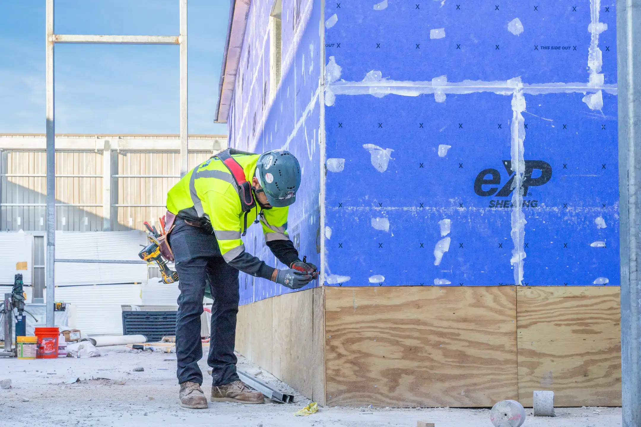 Man in safety gear working on sheeting the Riverside Lab