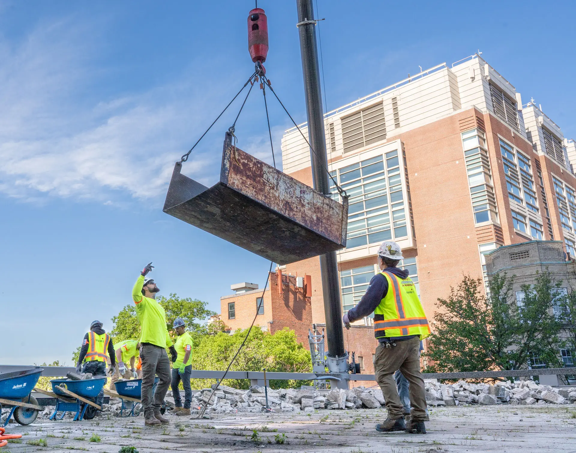 Large metal piece being lowered by a forklift