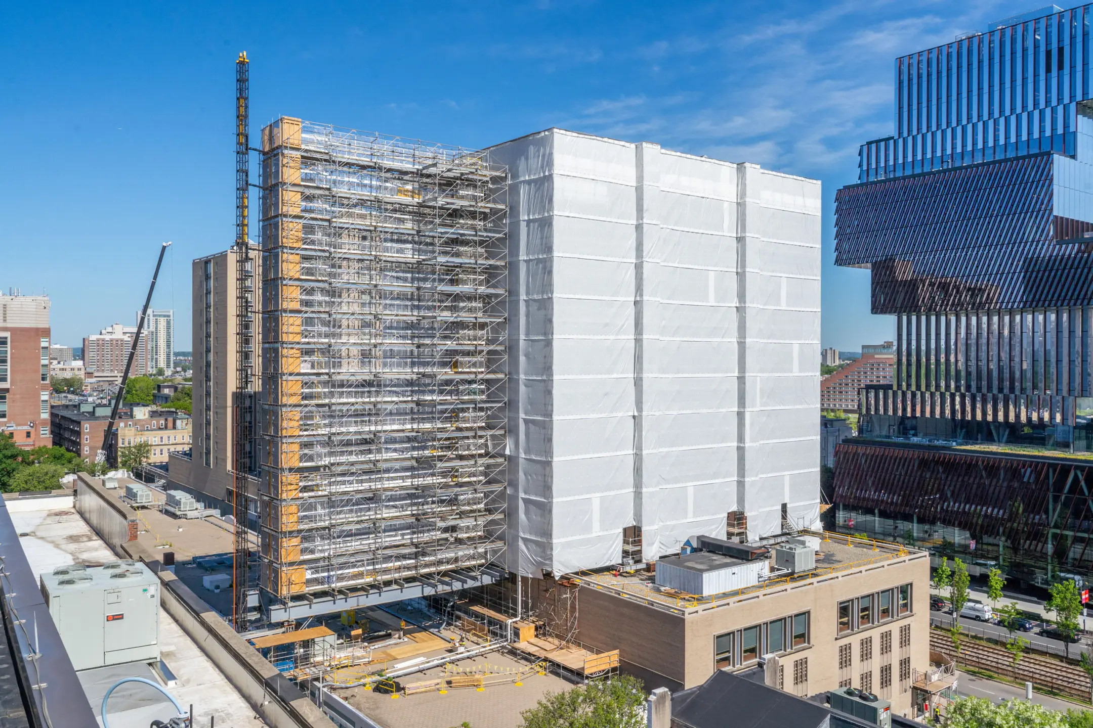 Multistory skyscraper covered in large white tarp