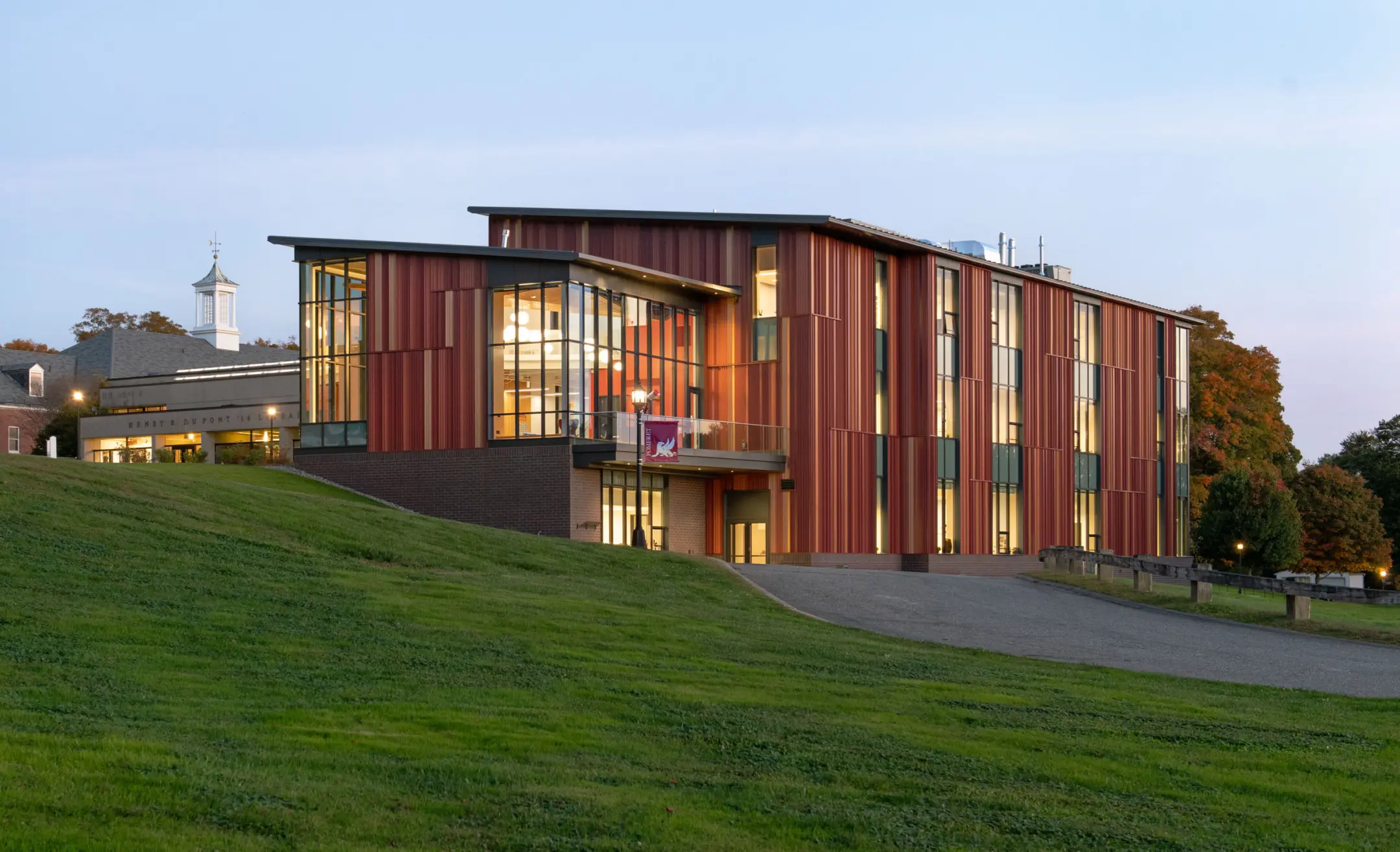Red three story building on a hill at Pomfret Academy