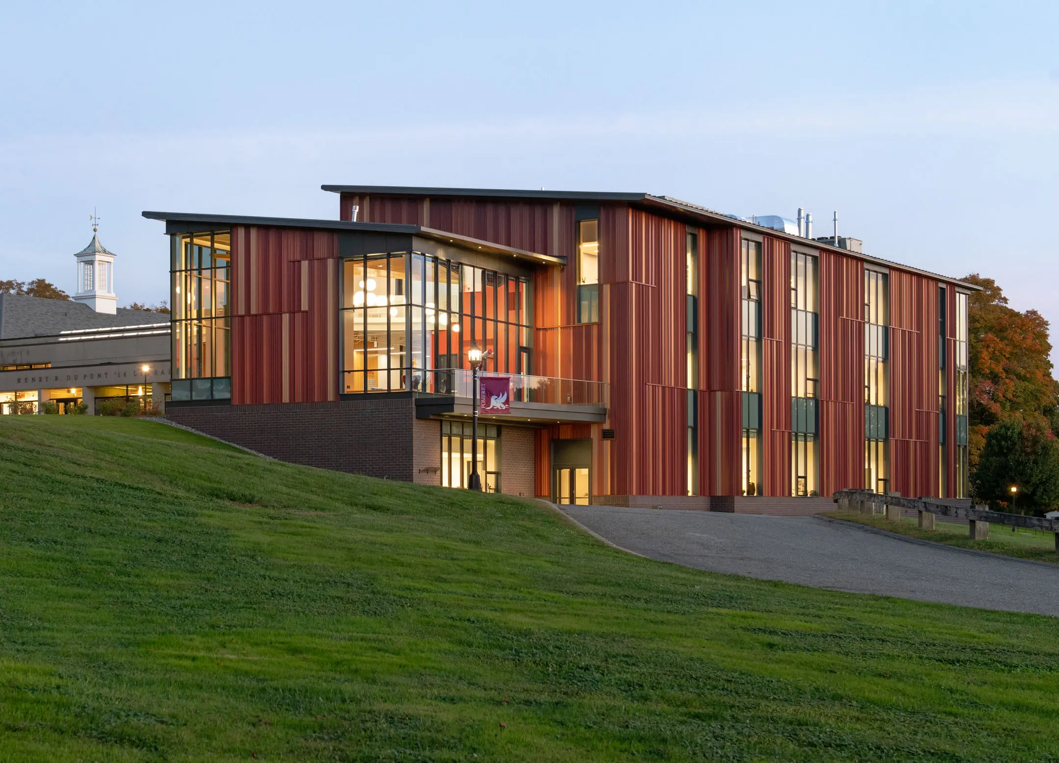 Red three story building on a hill at Pomfret Academy