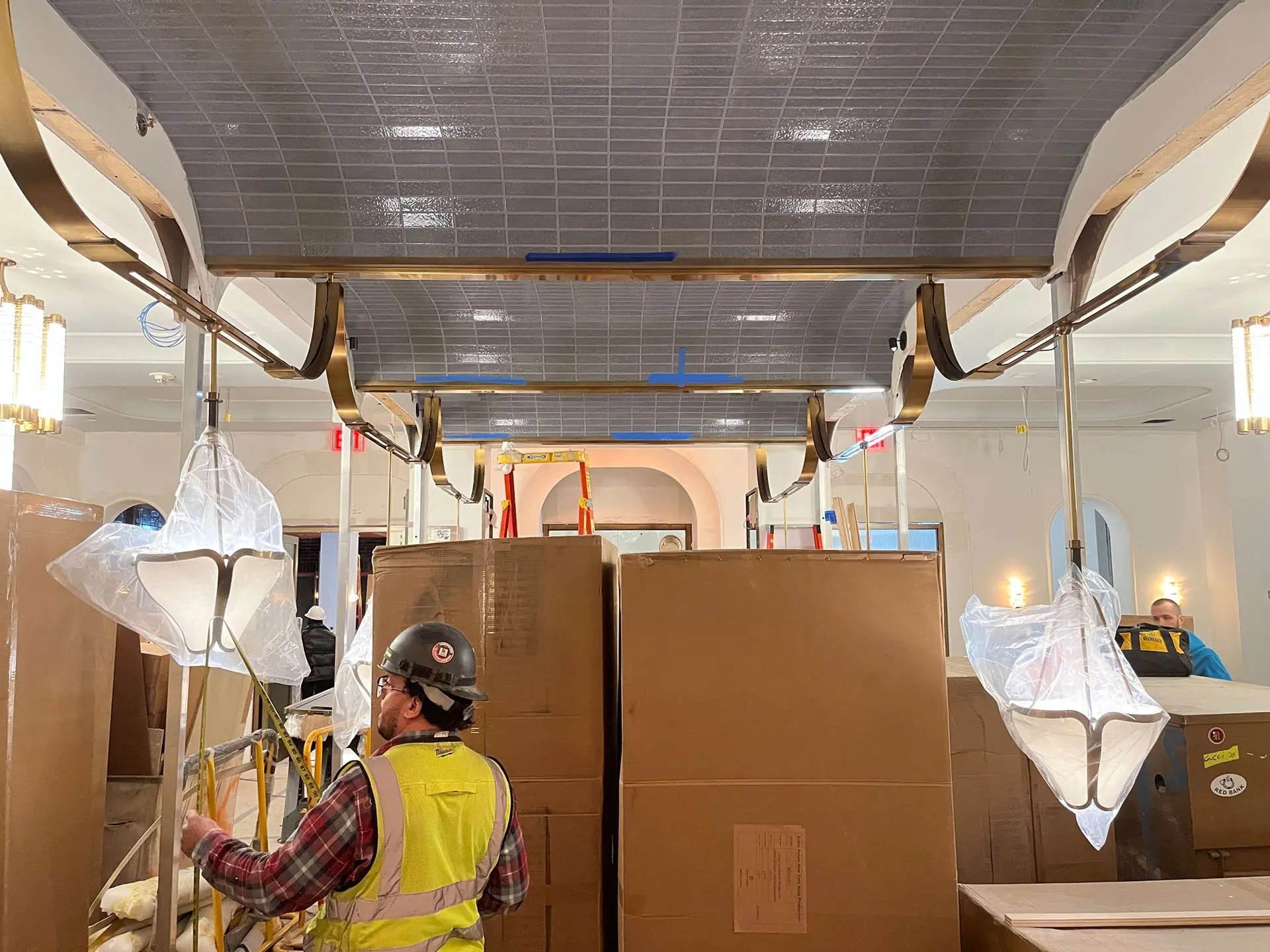 Workers installing pendant lamps in hotel