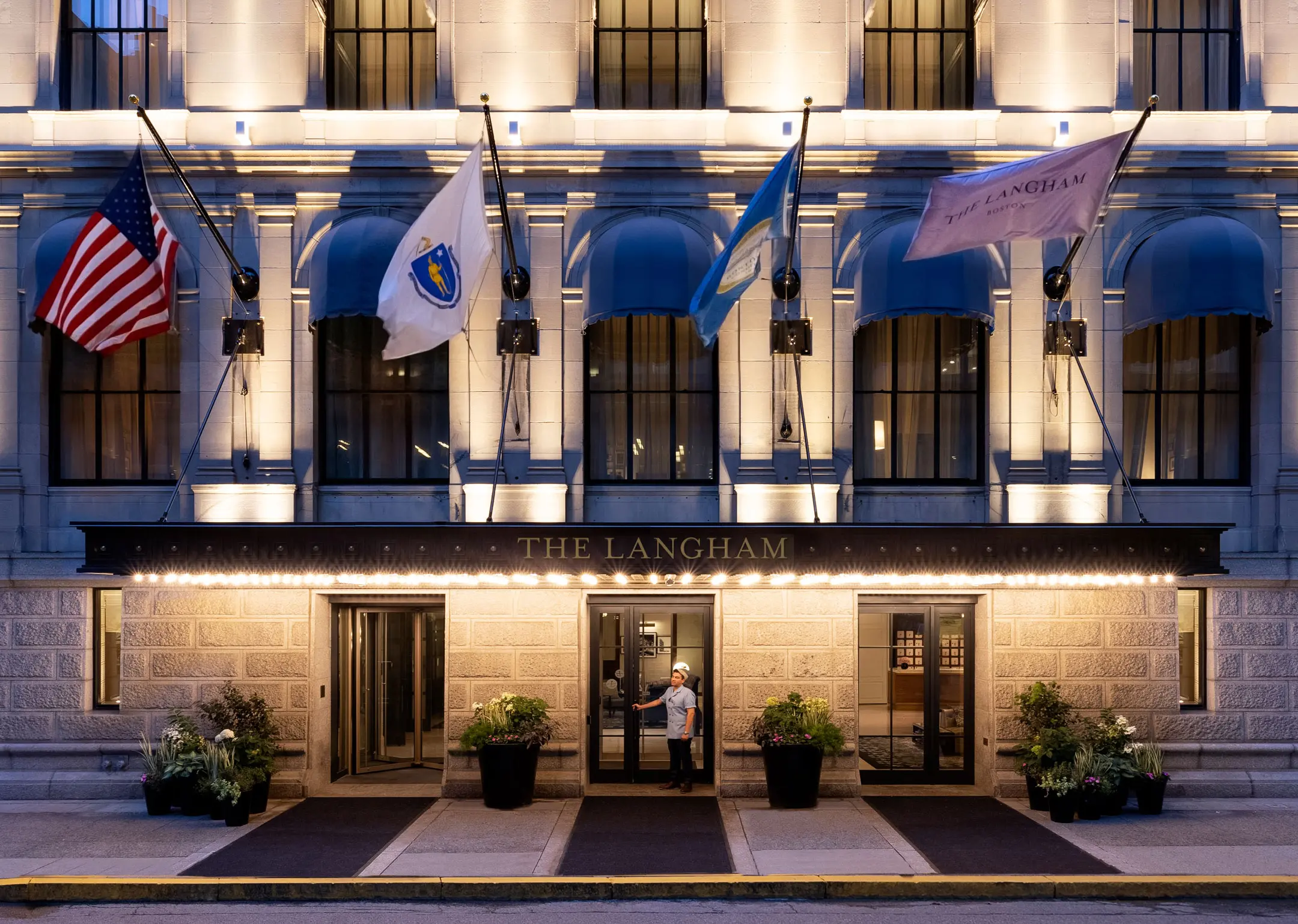 Exterior of hotel with bellhop holding door