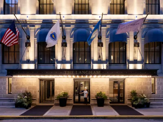Exterior of hotel with bellhop holding door