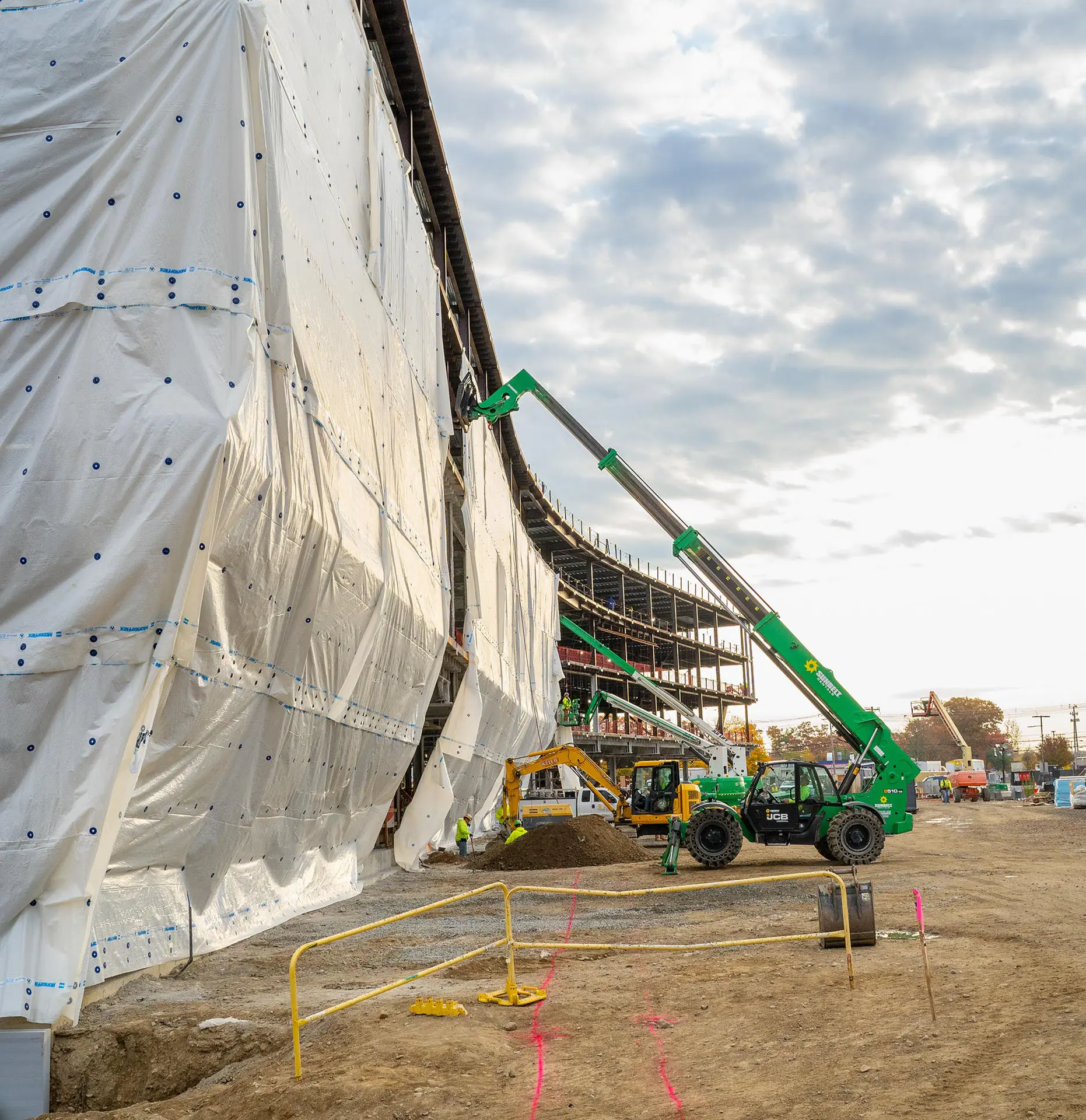 Boom fork lift lifting materials multiple stories up in building