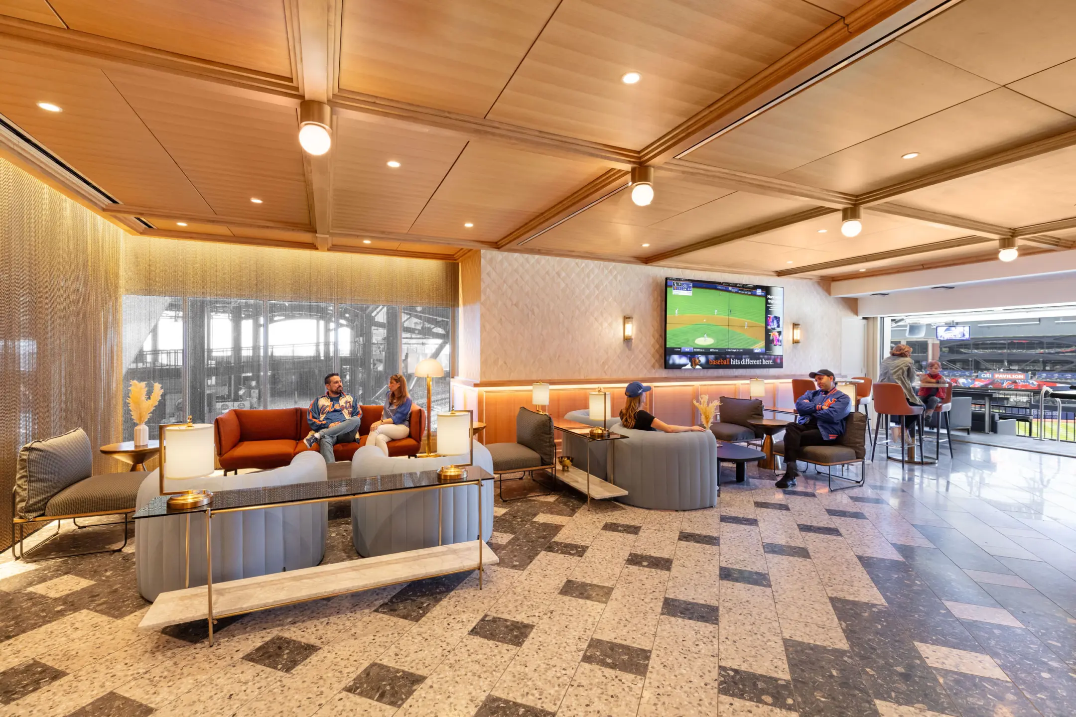 People in decadent lounge at baseball field