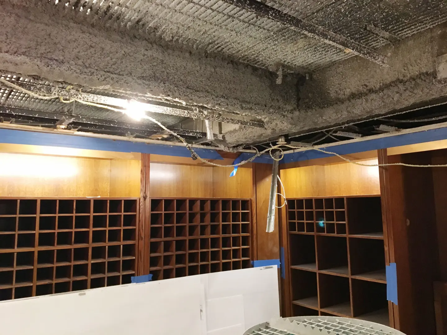 Fireproofing material on metal bars in ceiling of building