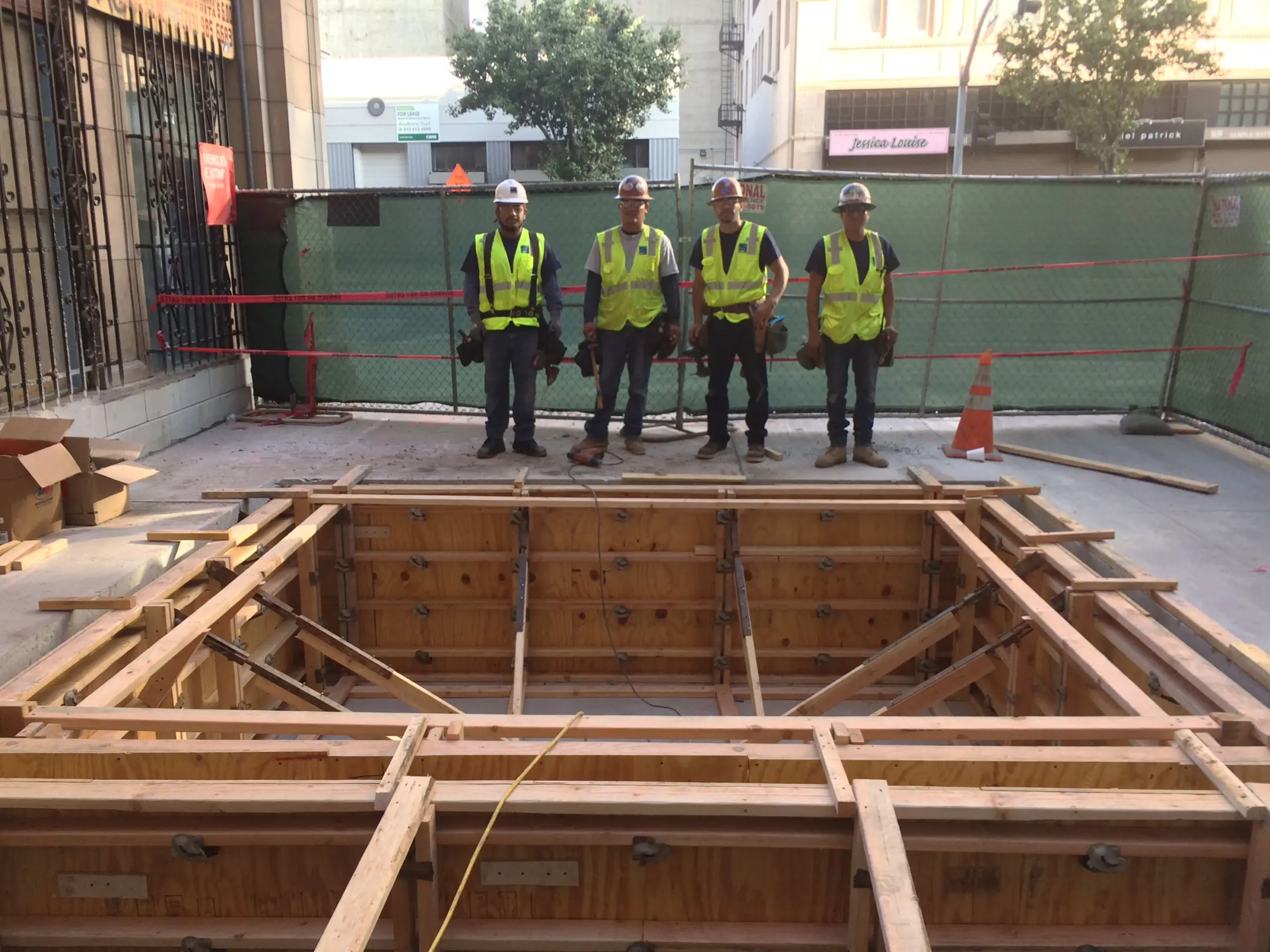 People standing in front of concrete as it sets