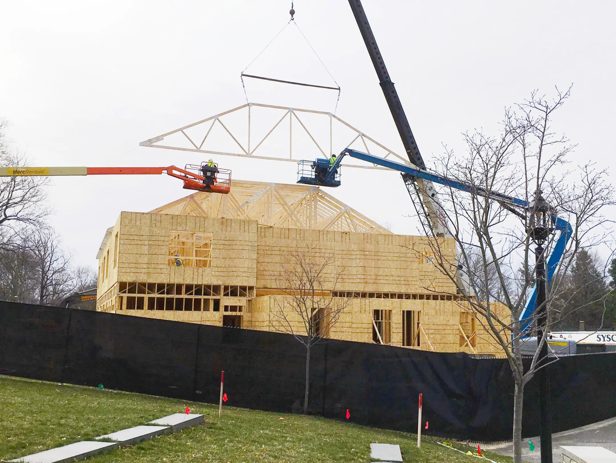 Wood structures being lowered on a building with a crane