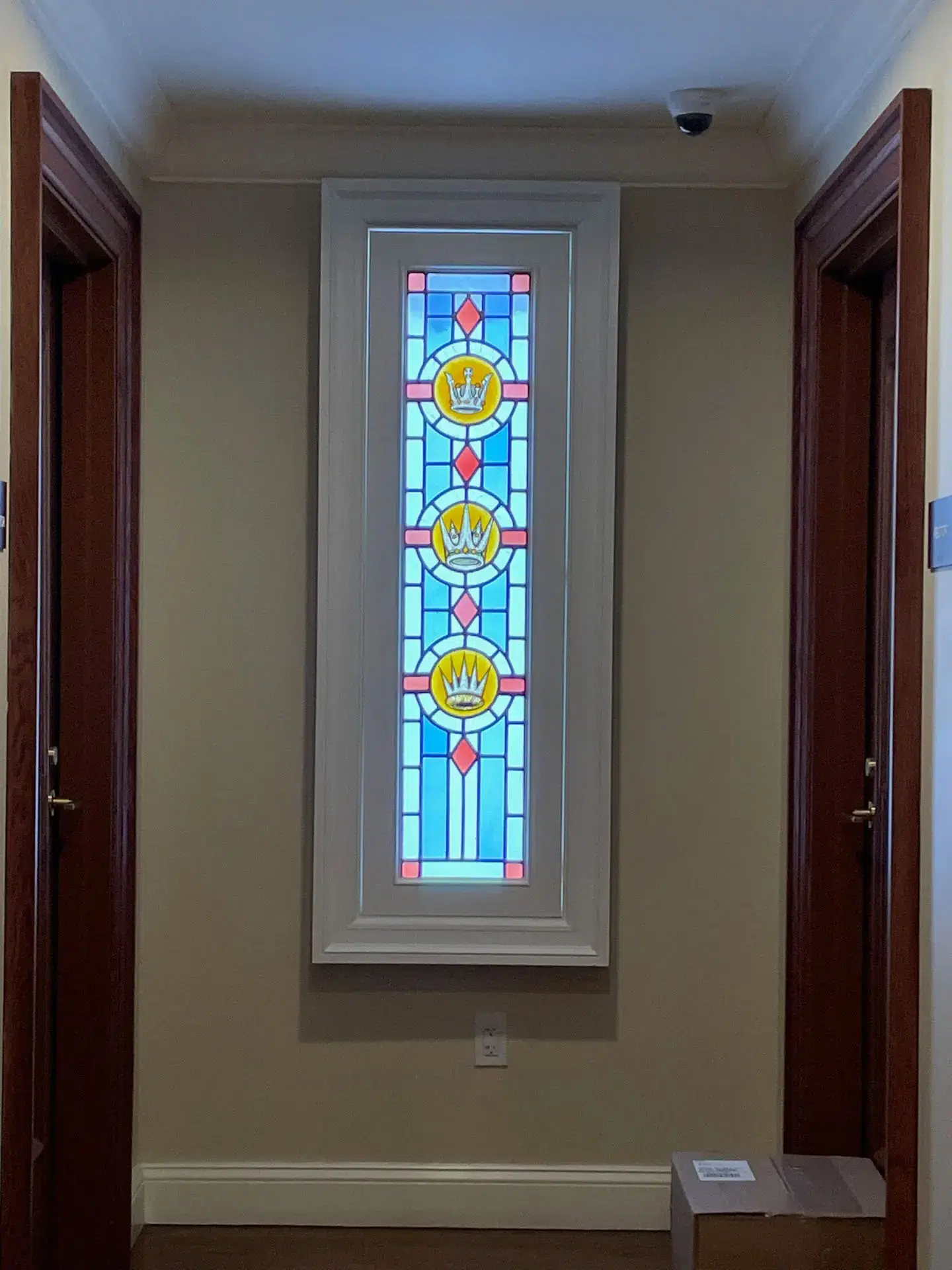 Stained glass window with crowns