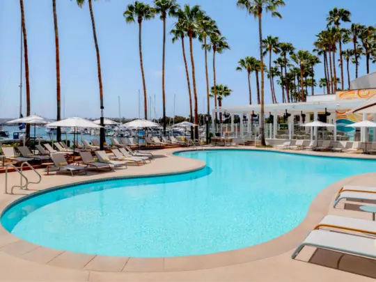 Pool with lawn chairs surrounding it on a marina