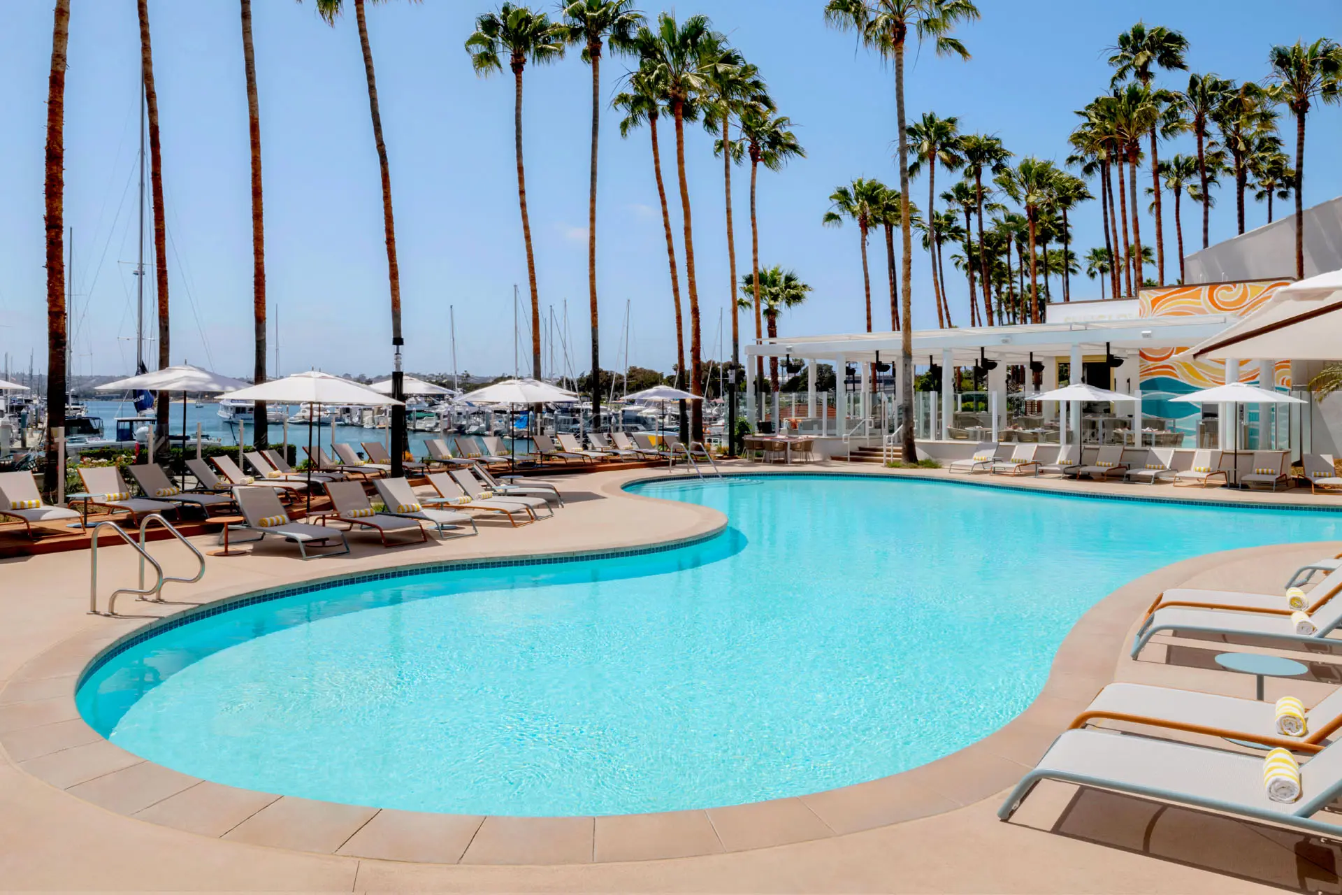 Pool with lawn chairs surrounding it on a marina
