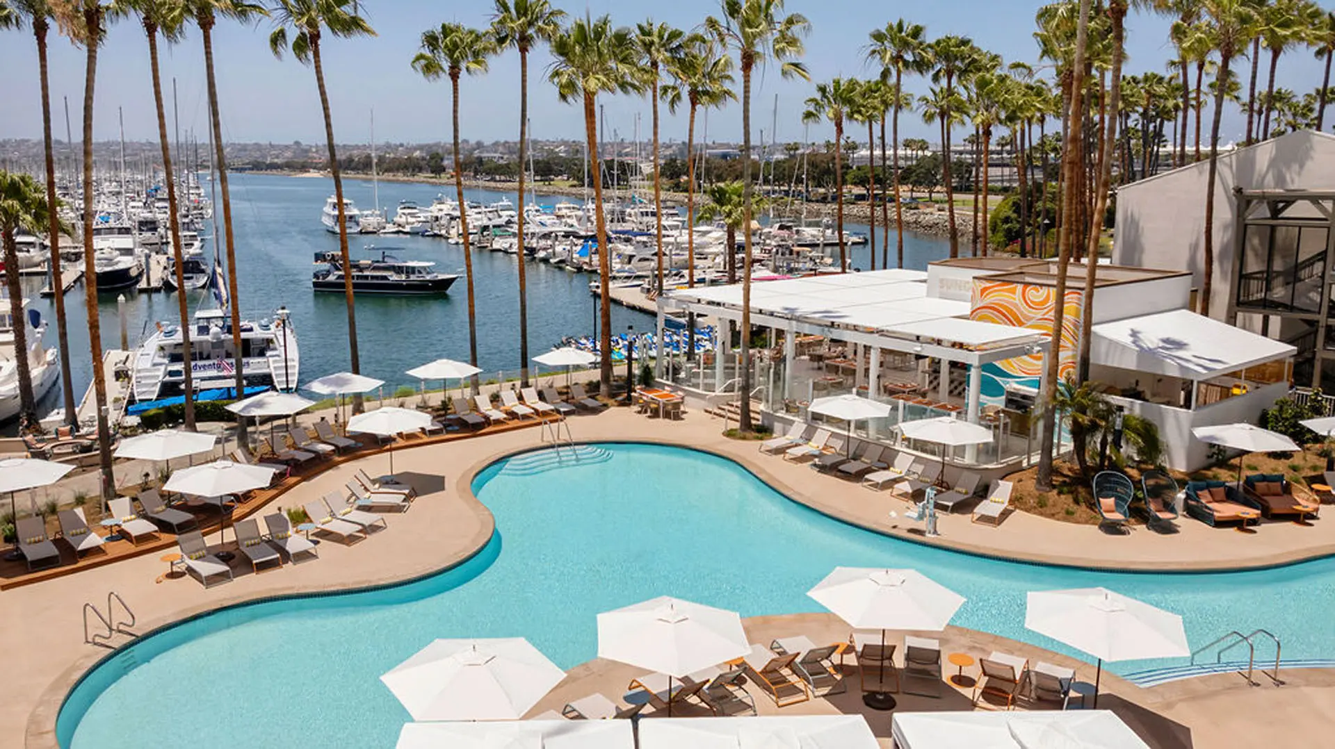 Pool with lawn chairs surrounding it on a marina