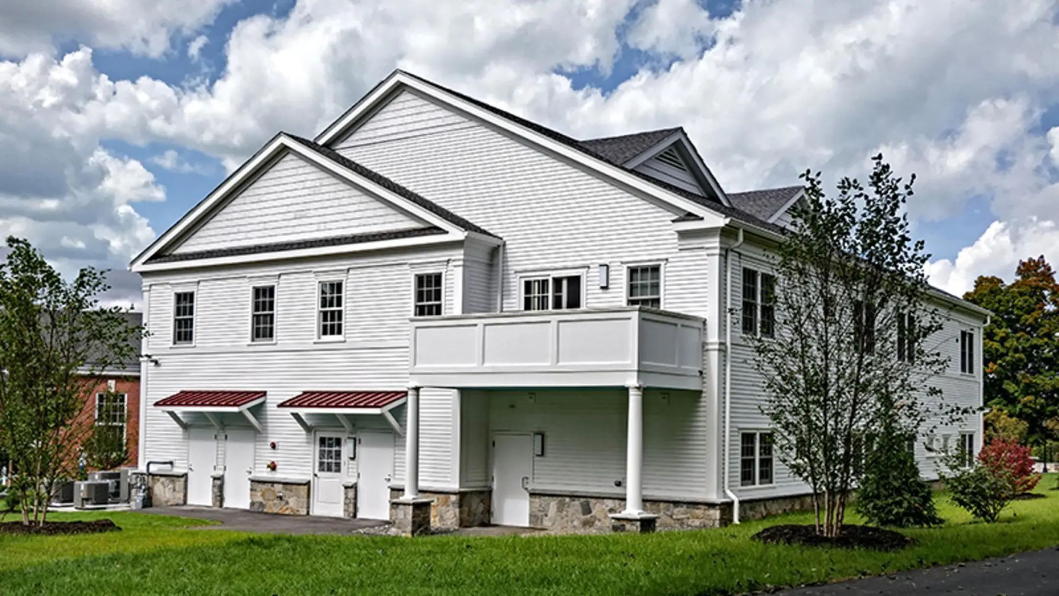 Rendering of white sided two story Pomfret Academy Health and Wellness Center