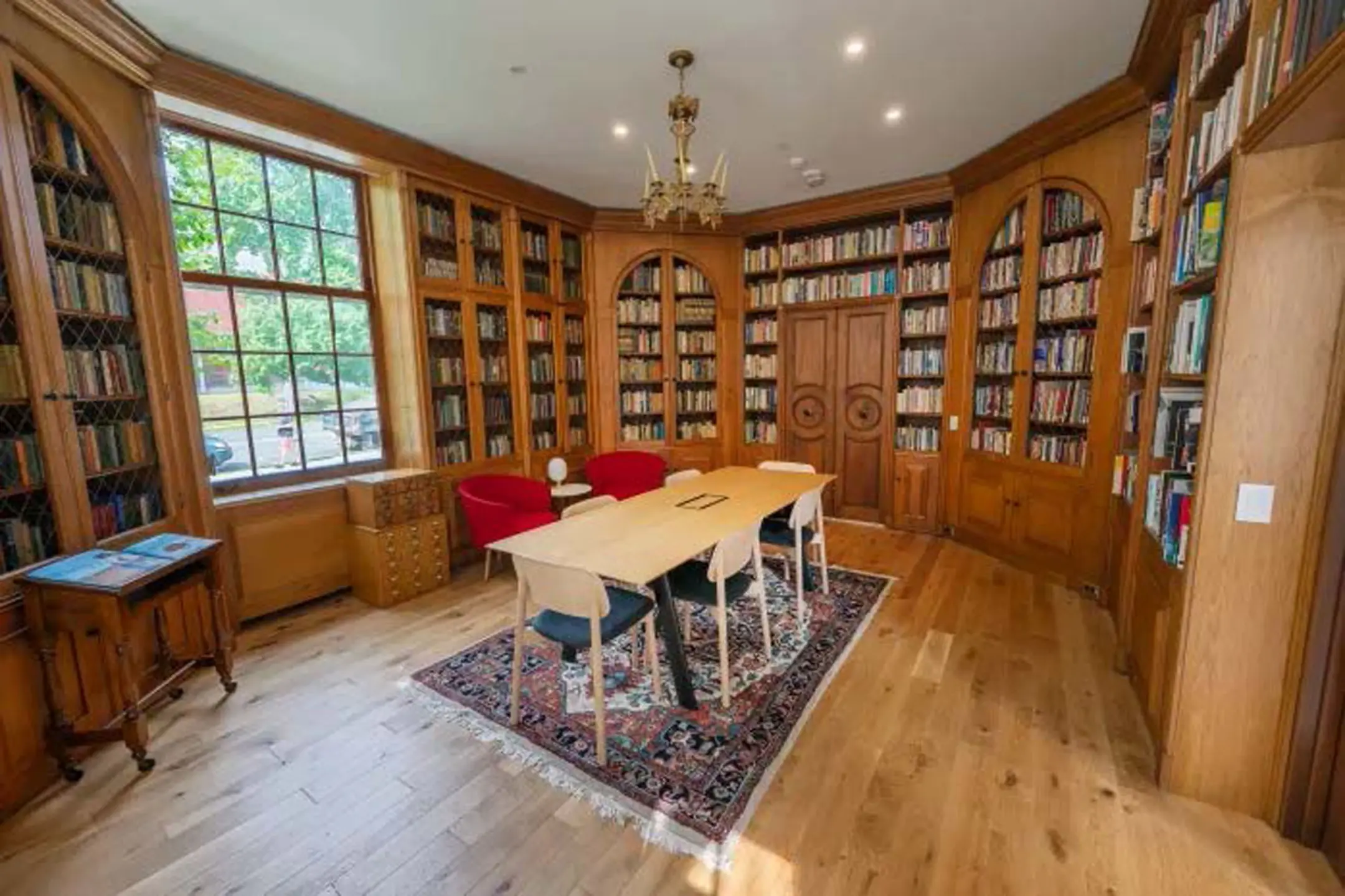 Table in room with bookshelves lining walls