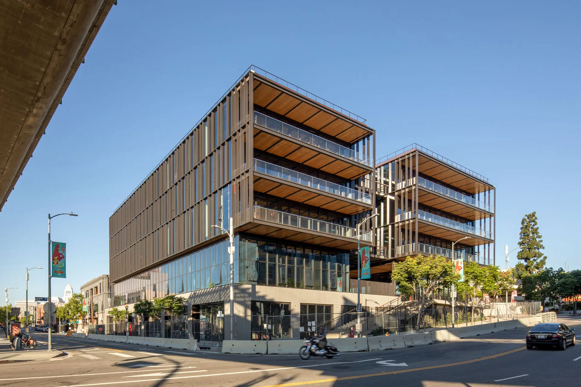 Exterior picture of corner of five story 843 North Spring Street building with glass walls, wooden flooring, and steel beams
