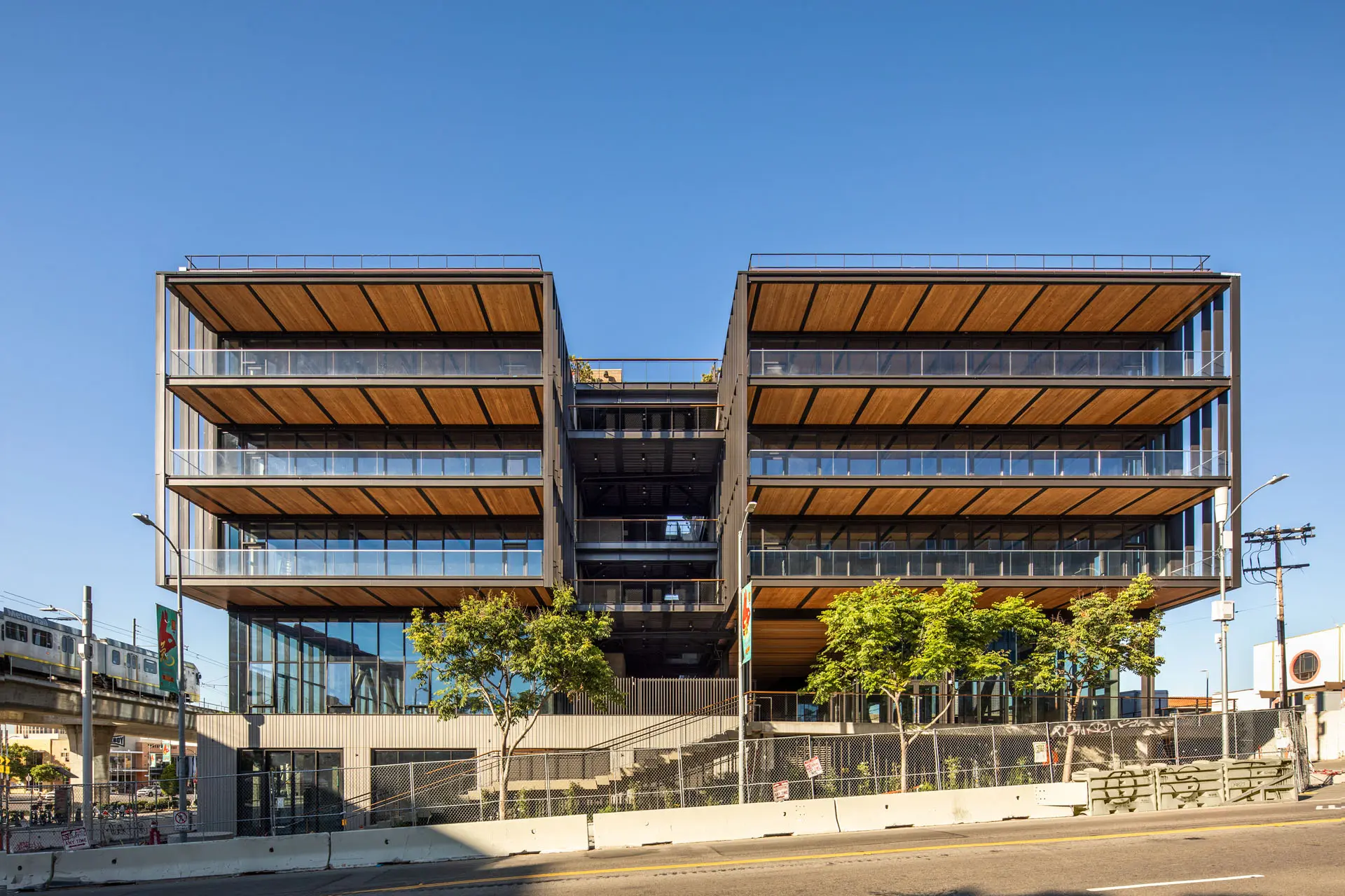 Exterior picture of five story 843 North Spring Street building with glass walls, wooden flooring, and steel beams