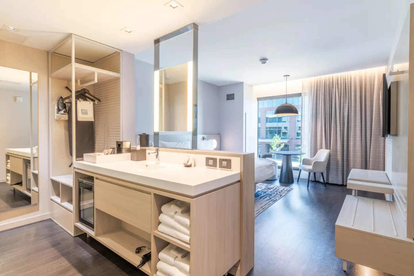 Hotel room with exposed sink and bed