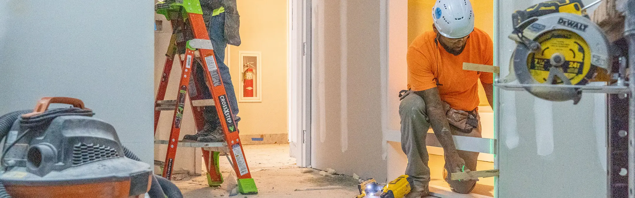 Men working on doorframes in house