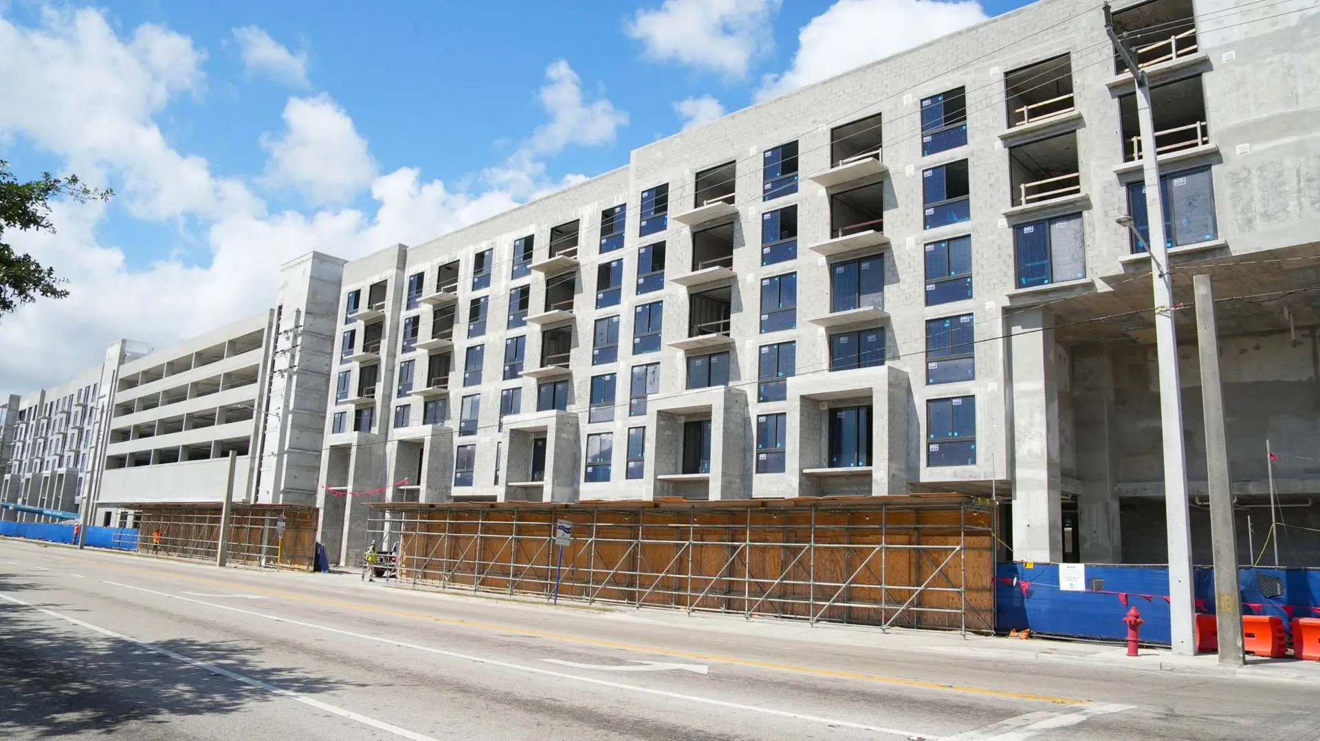 Worms eye view of concrete building with scaffolding under construction