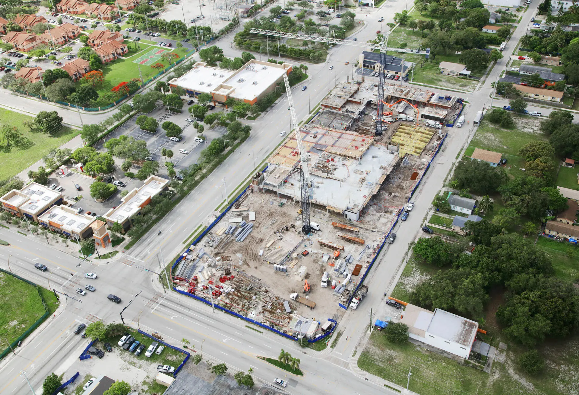 Overhead view of multiple cranes in construction zone